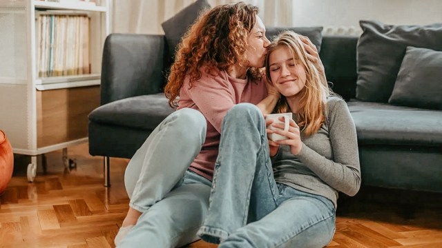 mom comforting teen daughter