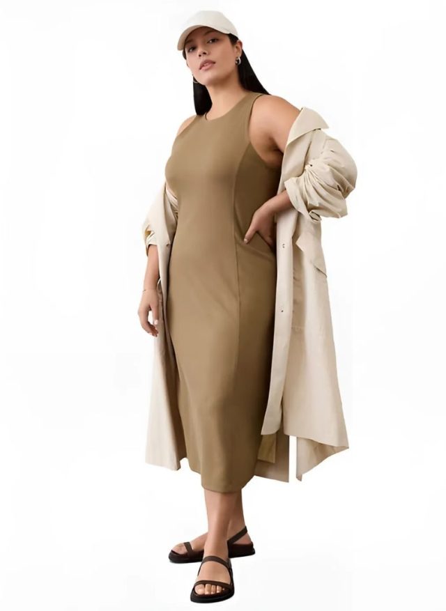 Person wearing the dress, a jacket, and a baseball cap