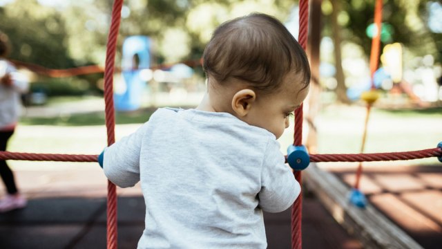 a baby on the rope climb after their mom checked that it's not too hot from the sun, one of our summer safety tips