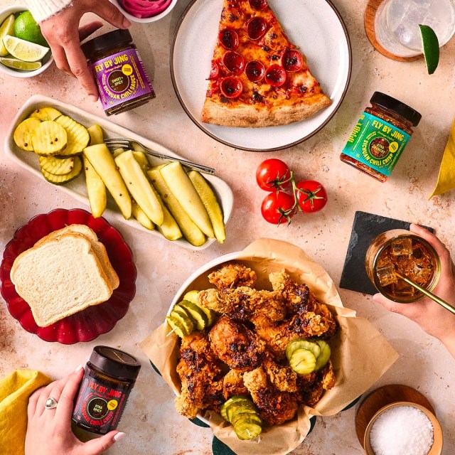 a dining table filled with foods and Fly by Jing sauces