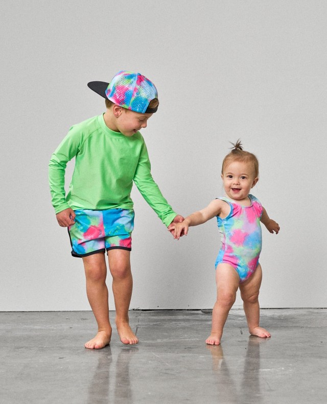 two children wearing neon swimsuits