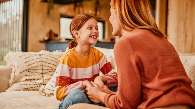 mother and daughter having a heartfelt conversation on the couch