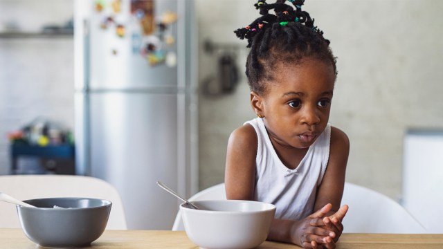 A young girl looking unimpressed with her food, following the release of a study that asks is picky eating genetic