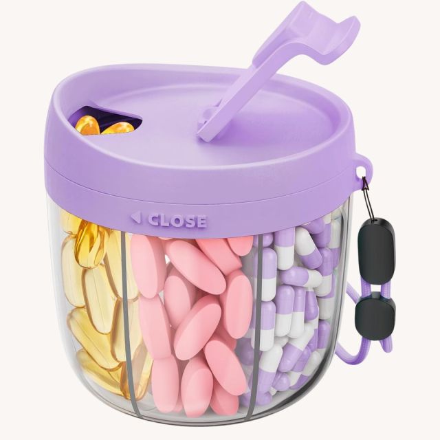 round travel pill organizer with purple lid