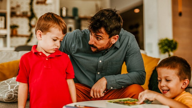 A little boy talking to his dad after some bad behavior