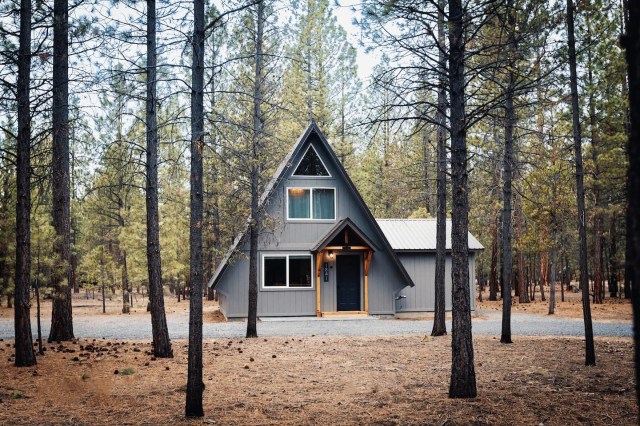 exterior of the a-frame home in wooded area