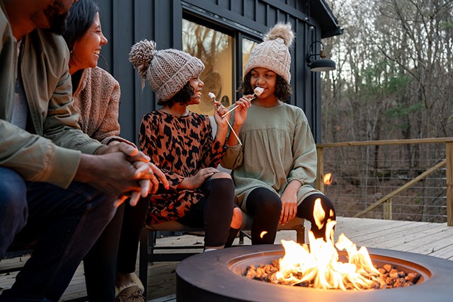 Young girls enjoying a bonfire with marshmallows, one of the best autumn family activities