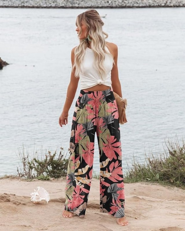 person standing on shore wearing floral wide-leg pants