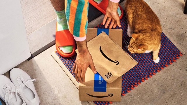 person retrieving amazon packages from front porch