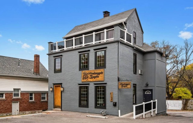 exterior of a bagel shop with a loft airbnb above