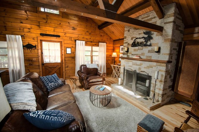 the living room of a log cabin airbnb
