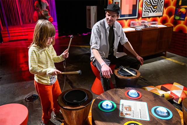 A dad and daughter drumming at Kidspace Museum's Wired for Wonder exhibit