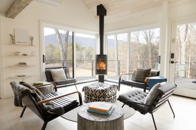 neutral minimalist living area with a wood burning stove