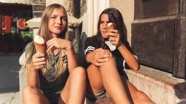 two teens eating ice cream looking too cool for parents