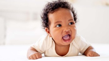 A baby lying on the bed that could be in the midst of the four month sleep regression