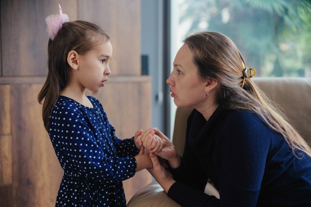 girl talking to her mom