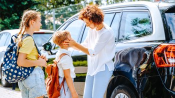 A mom dropping her kids at school knowing they can be in contact on their Spacetalk watches