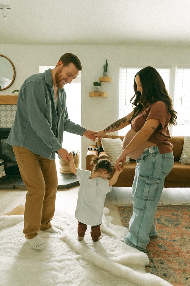 A couple and their toddler having a dance party, one of the best faceless photo ideas