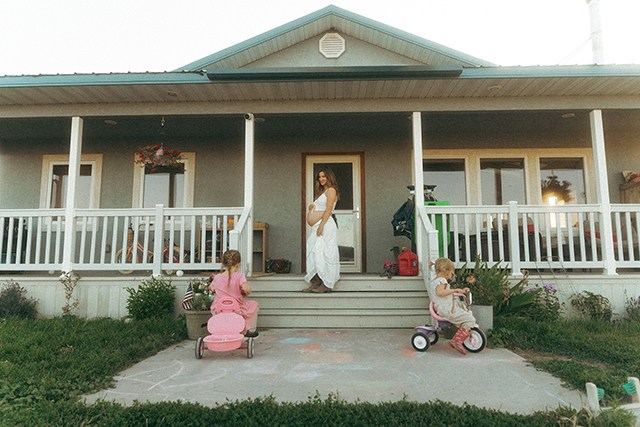 a mom and her kids outside with the kids looking up at the mom, one of the best faceless photo ideas