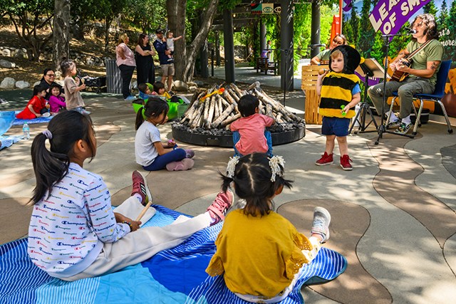 Kid in bee costume performing at Kidspace Campout