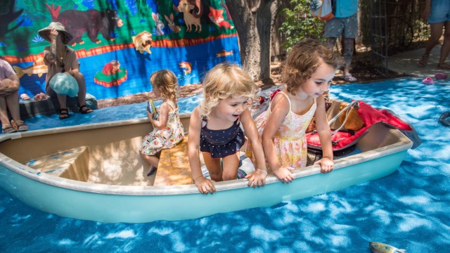 Two toddlers in a pretend boat at Kidspace Campout